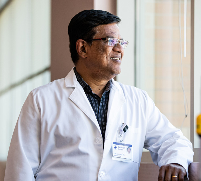 A Physician looking fondly out the window - PARTNERS concept image